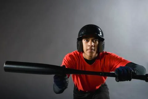 Mixed race baseball player ready to bunt with baseball bat Stock Photos