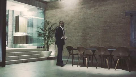 Mixed race boss drinks coffee in luxury penthouse apartment Stock Footage 105012684