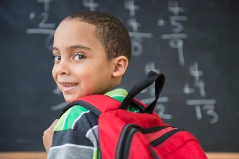Mixed race boy doing math problems at board in class Stock Photos