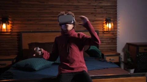 Mixed race boy taking off VR glasses during game 스톡 동영상 125410441