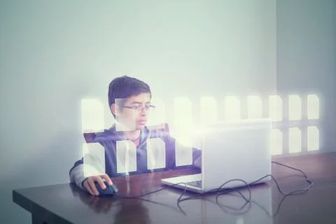 Mixed race boy using computer with holographic files Stock Photos