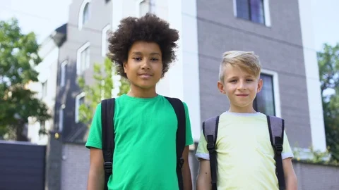 Mixed race boys looking at camera, best friends, happy childhood, togetherness Vídeo Stock 117207835