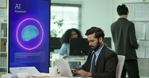 Mixed race businessman looking at AI assistant screen while working on computer. Stock-Footage 335851553