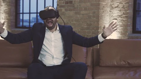 Mixed race businessman using virtual reality headset enjoys himself Stock Footage 104561919