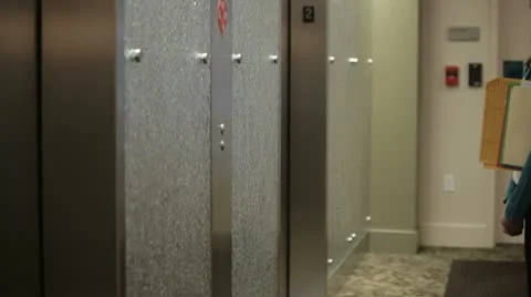 Mixed race businesswoman entering elevator Stock Footage
