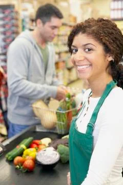 Mixed Race cashier at grocery store Stock Photos