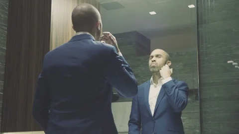 Mixed race CEO checks himself in mirror then puts on glasses before meeting CU Stock Footage 105010901