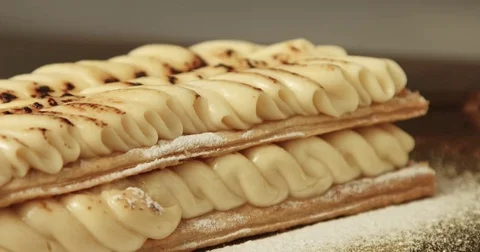 Mixed race chef put the last one puff pastry level on pastry Stock Footage 76281049