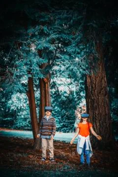 Mixed race children using virtual reality goggles outdoors Stock Photos