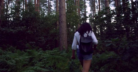 A Mixed Race Curly Haired Young Student Girl Exploring the Forest In The Summer. Stock Footage 94225262