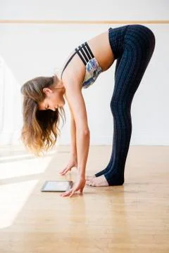 Mixed race dancer stretching in studio 库存照片