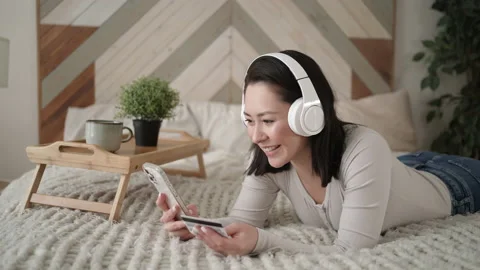 Mixed race female client holding banking credit card and smart phone involved in Stock Footage 169244912