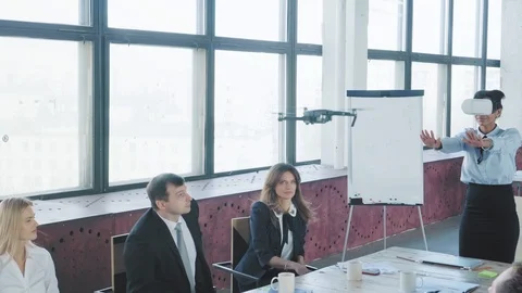 A mixed-race female engineer controls the drone with hand gestures and VR Stock Footage 108186148