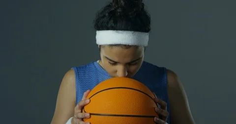 Mixed Race Female Looking Down To Basketball Then Looking To Camera Stock Footage 112766905