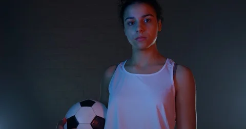 Mixed Race Female Model Holding Up Football And Looking Proudly Into Camera Stock Footage 112767519