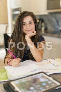 Mixed race girl doing homework Stock-Fotos