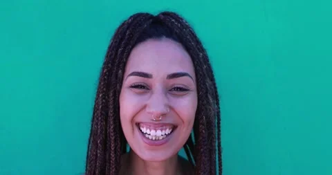 Mixed race girl smiling on camera with green background Stock Footage 156452000