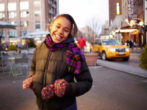Mixed race girl smiling on city street, New York, New York, United States Stock Photos
