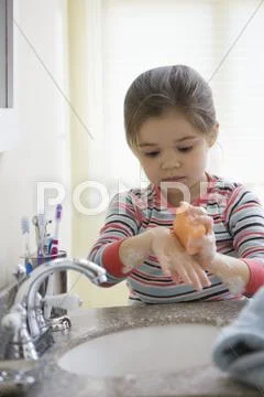 Mixed race girl washing hands Stock Photos