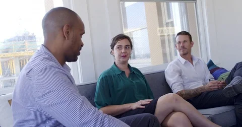 Mixed race group of friends talking on sofa MS 4K Stock Footage 80295766