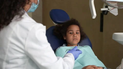 Mixed race kid during teeth examination at dentist Stock Footage 156871947