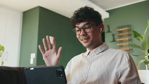 Mixed race male interacting with class mates online learning waving to students Stock Footage 155836909