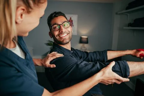 Mixed race male patient practising rehabilitation exercises Stock Photos