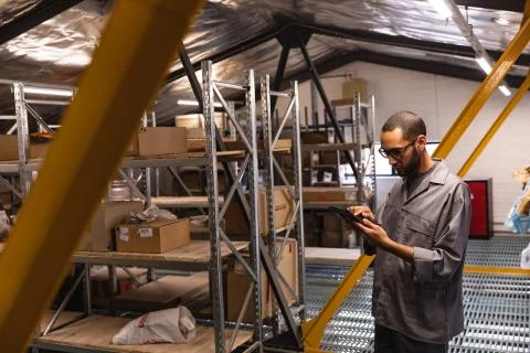 Mixed race man checking storage on a tablet 写真素材