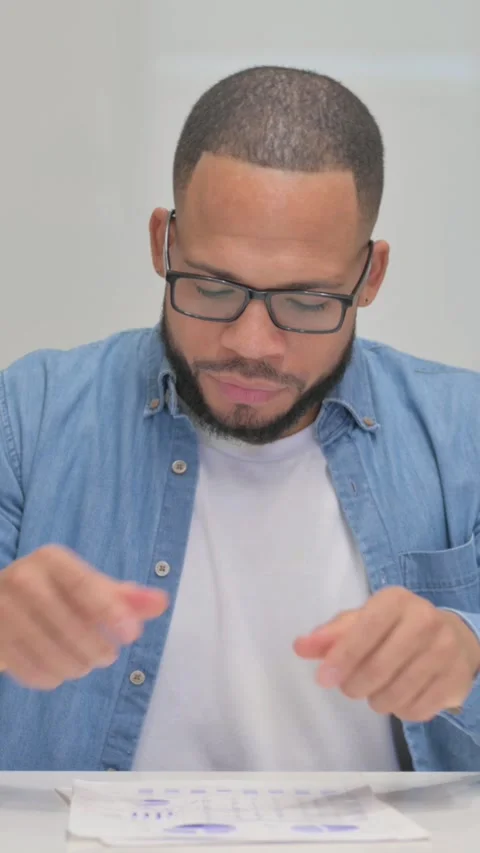 Mixed Race Man Feeling Upset while Reading Contract, vertical video Vidéo 325700333