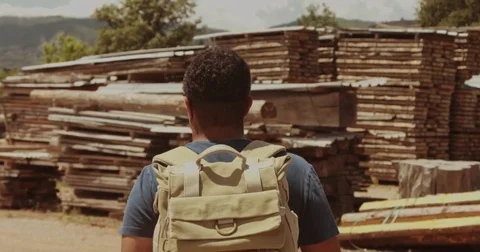 Mixed race man goes forward through wooden farm Stock Footage 76092685