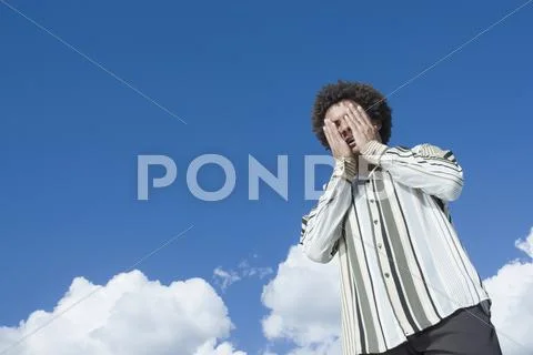 Mixed Race man with hands on face Stock-Fotos