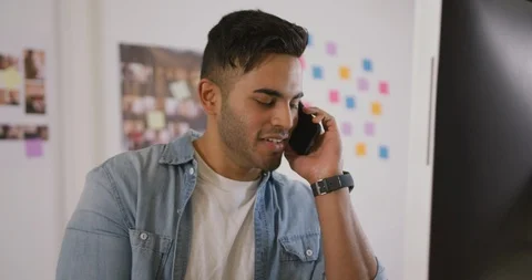 Mixed race man phoning in creative office Stock Footage 124597521