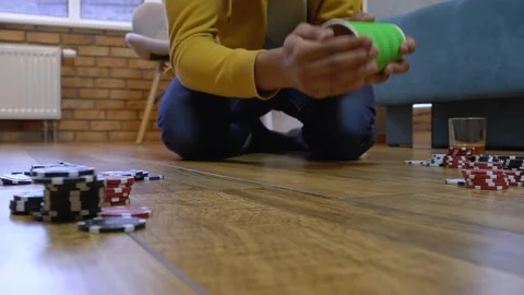 Mixed-race man rolling dice, poker chips on the floor, leisure at weekend, game Stock Footage 125519760