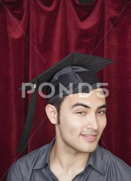 Mixed race man wearing mortarboard Stock Photos