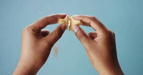 Mixed race mans hand open a fortune cookies Video stock 77251936