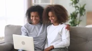 Mixed Race Mother Daughter Watching Movie On Laptop At Home Stock Footage