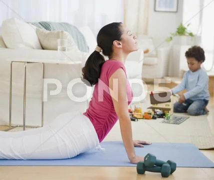 Mixed race mother practicing yoga Stock Photos