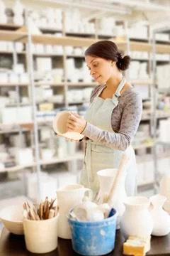 Mixed race potter working in workshop Stock Photos