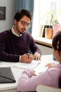 Mixed race teacher solving problem with schoolgirl Stock Photos