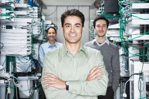 Mixed race team of technicians working on computer servers in a computer server Stock Photos