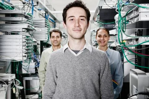 Mixed race team of technicians working on computer servers in a computer server Stock Photos