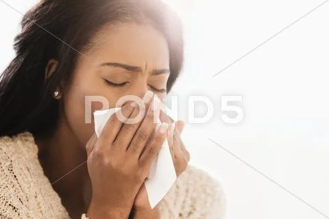 Mixed Race Woman Blowing Her Nose
