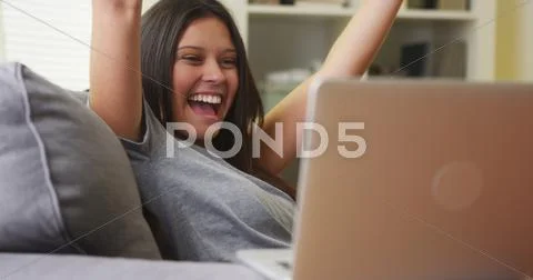 Mixed race woman excited and happy about her team winning Stock Photos