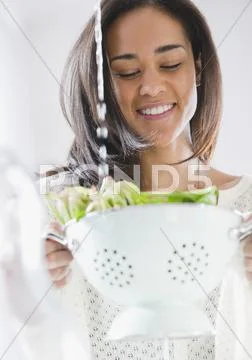Mixed Race Woman Rinsing Spinach