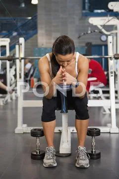 Mixed Race Woman Sitting In Health Club