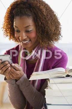 Mixed Race Woman Text Messaging On Cell Phone