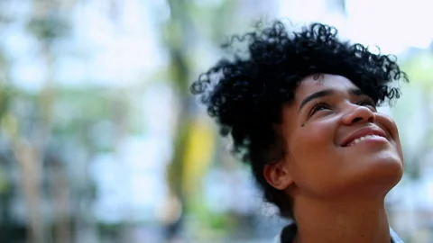 Mixed race young black African woman looking up to the sky smiling Stock Footage
