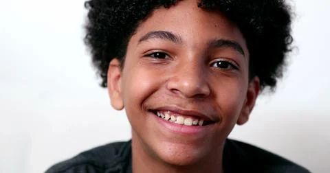Mixed race young boy smiling at camera portrait. Ethnically diverse male kid Stock Photos