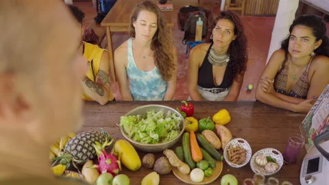 Mixed raced group preparing salad during cooking class. Healthy food and Stock Footage 219019072