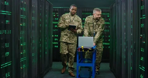 Mixed-races army technical workers coming with tools to database center to Stock Footage 128722019